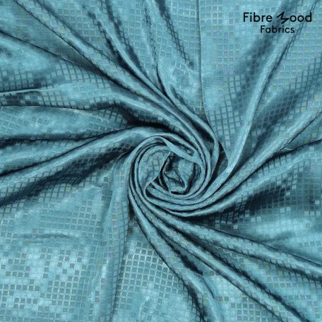 Deze geweven glanzende jaquard stof in de kleur petrol wordt verwerkt in Fibre Mood nummer 26 / patroon Risa