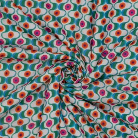 Een geweven stof met een opvallend retro patroon met stippen in felle kleuren. Super leuk om bloezen, shirts of jurken van te naaien